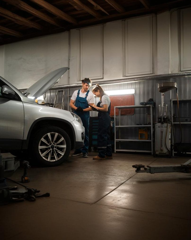 Mechanics fixing a car